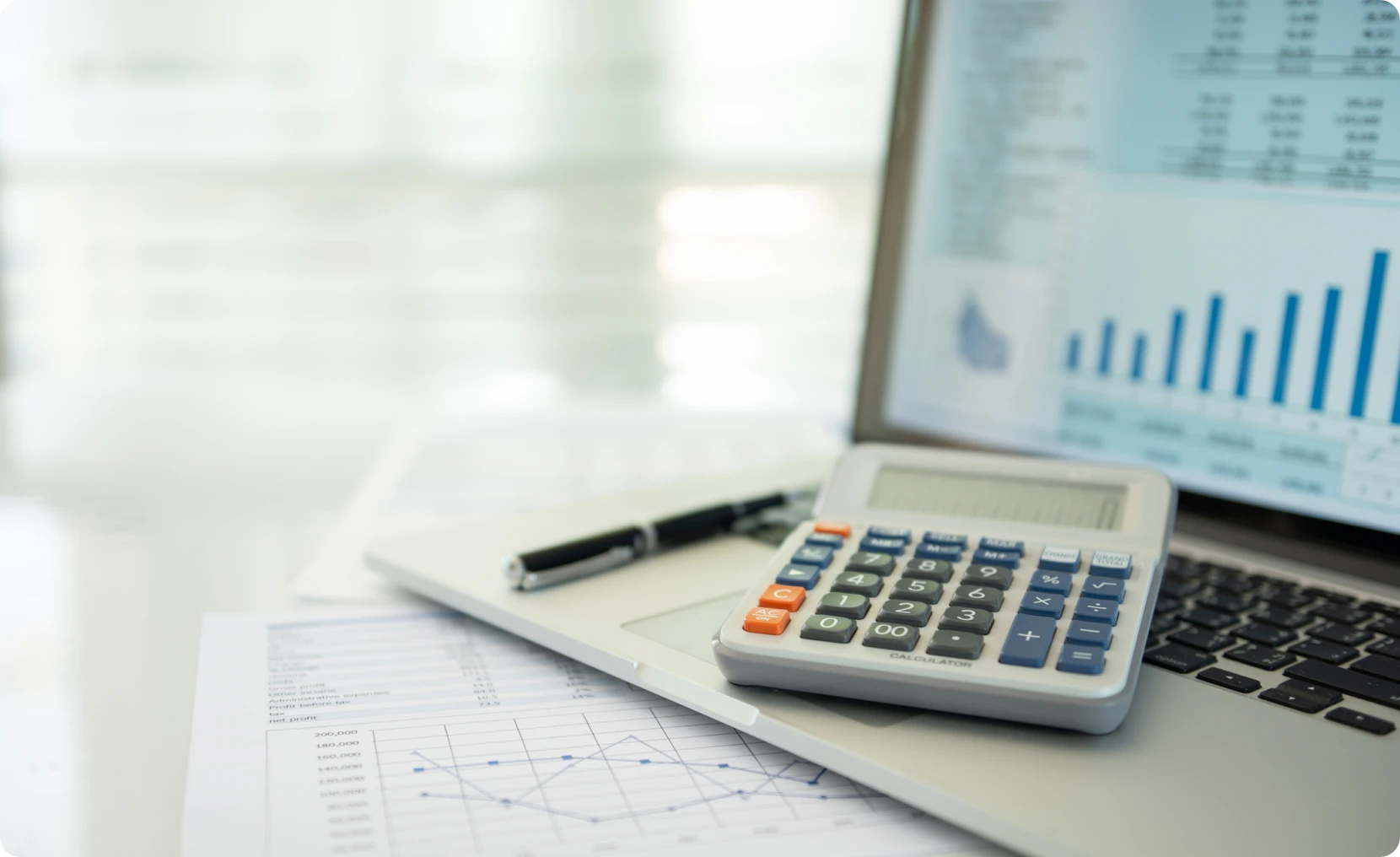 Business workspace with graphs and calculator